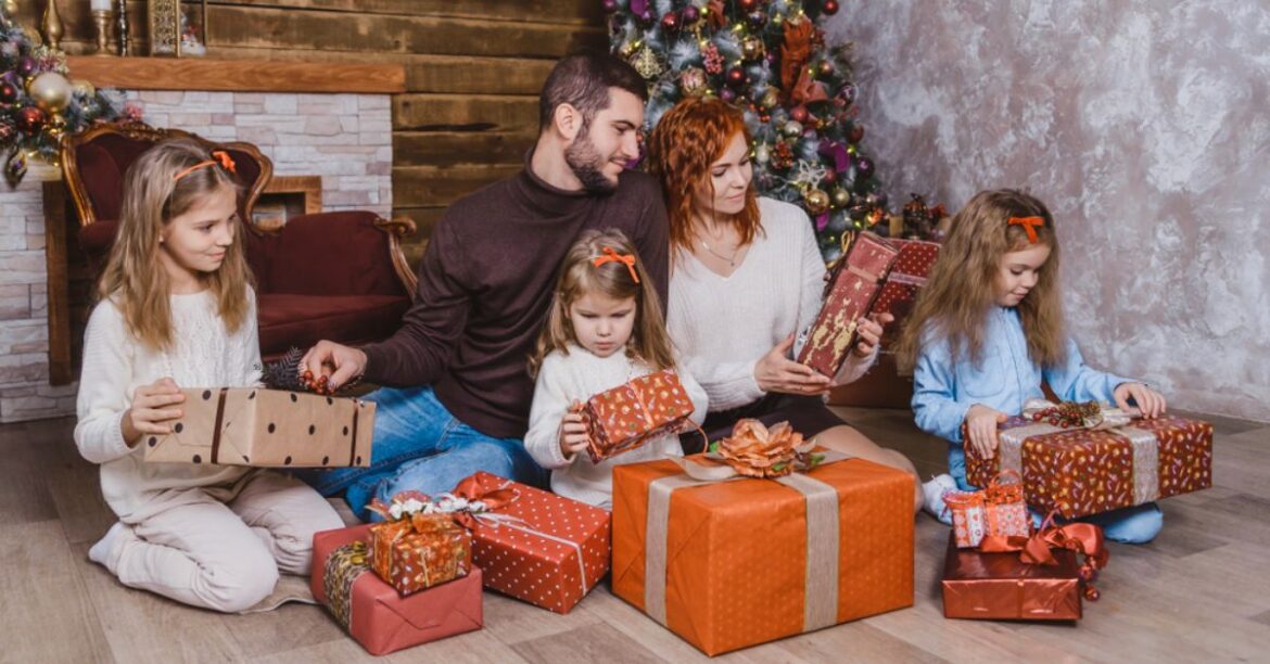 A festive image of a family gathering around a beautifully decorated Christmas tree, with presents and holiday decorations in the background.